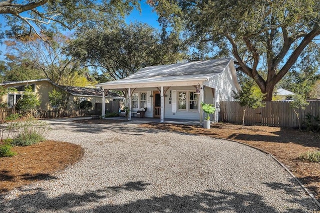 1106 George Lotson Ave, Saint Simons Island, GA 31522 - exterior space with gravel driveway, a porch, and fence