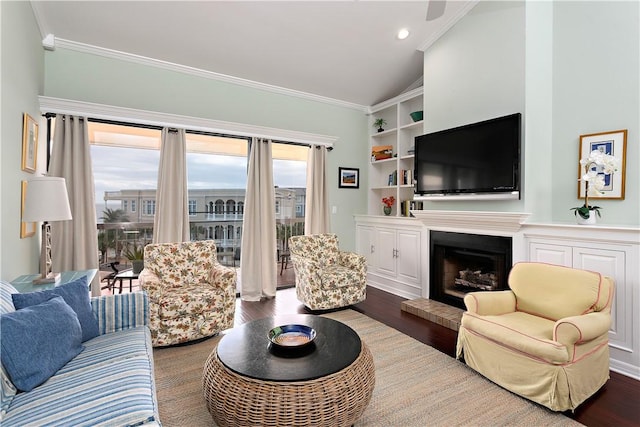 living room featuring ornamental molding, lofted ceiling, and hardwood / wood-style floors