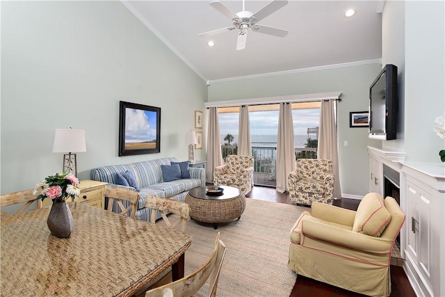 living room with lofted ceiling, hardwood / wood-style floors, ornamental molding, and ceiling fan