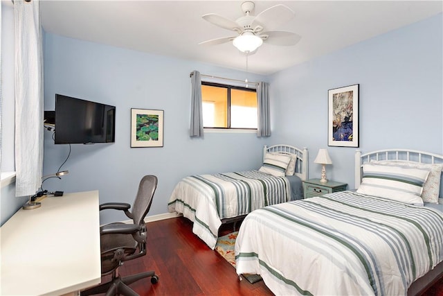 bedroom with dark hardwood / wood-style flooring and ceiling fan