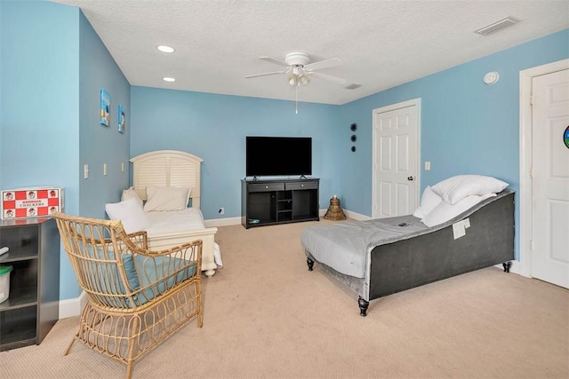 bedroom with carpet, a textured ceiling, and ceiling fan