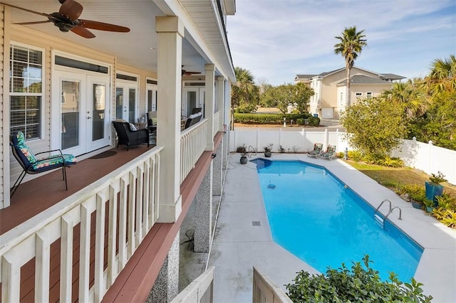 view of pool with french doors and ceiling fan