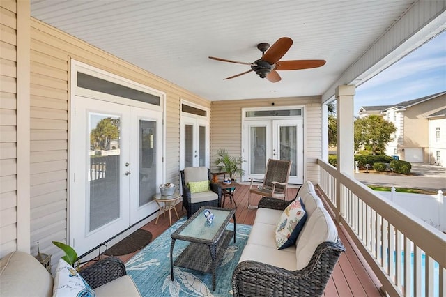 deck with french doors, an outdoor living space, and ceiling fan