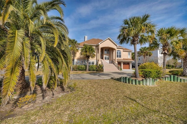 view of front of house featuring a garage and a front lawn