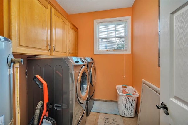 laundry room featuring cabinets, light tile patterned flooring, and washing machine and clothes dryer