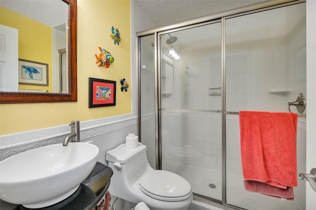 bathroom with vanity, toilet, and a shower with shower door