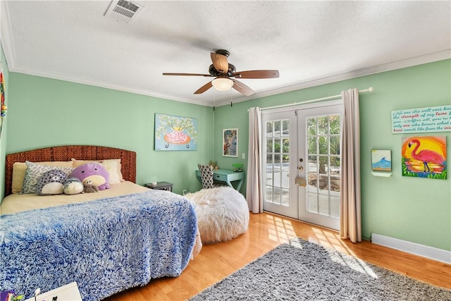 bedroom featuring access to exterior, french doors, ceiling fan, crown molding, and wood-type flooring