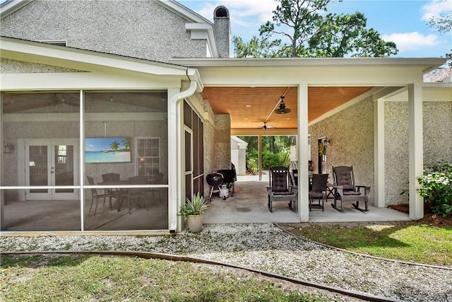 view of patio / terrace with area for grilling, ceiling fan, and a sunroom