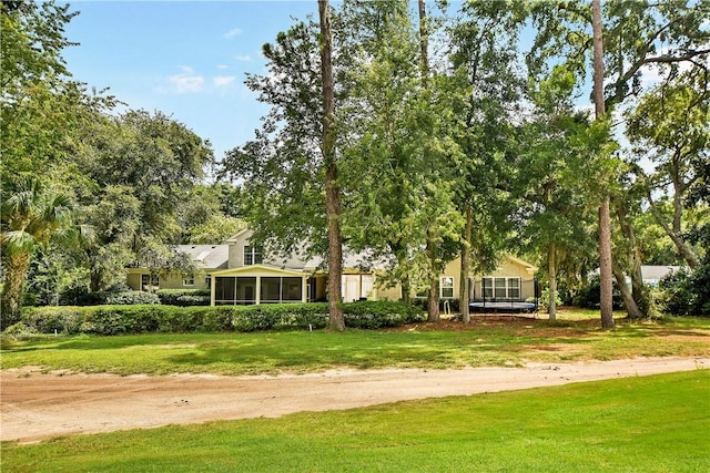 view of front facade featuring a sunroom and a front yard