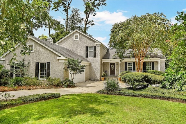 view of property with a garage and a front yard