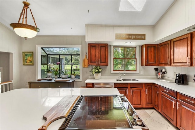 kitchen with sink, light tile patterned flooring, decorative light fixtures, and plenty of natural light