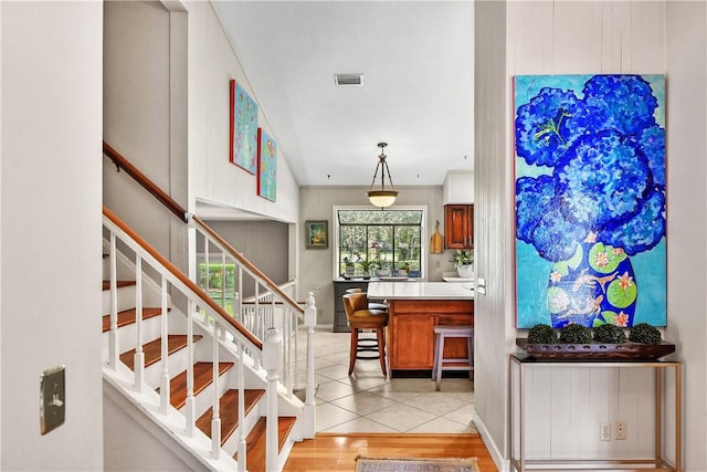 staircase with hardwood / wood-style flooring