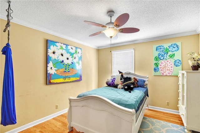 bedroom featuring a textured ceiling, ceiling fan, crown molding, and light hardwood / wood-style flooring