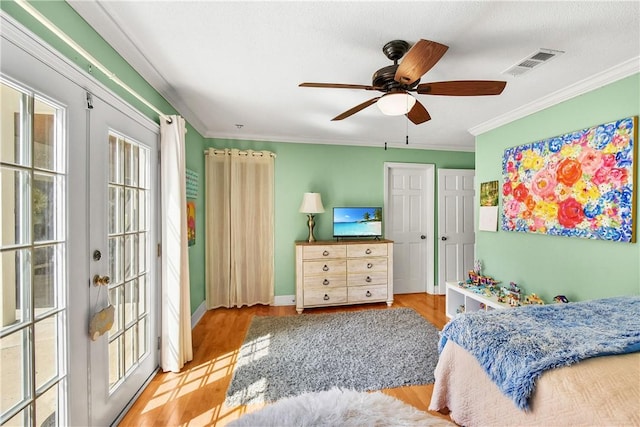 bedroom with ceiling fan, crown molding, french doors, and light wood-type flooring