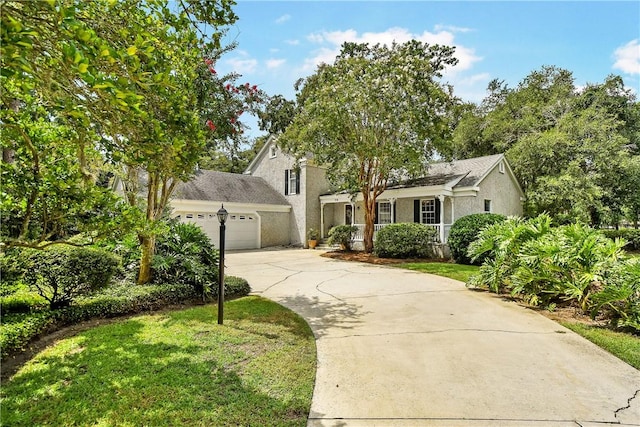 view of front of house with a front yard and a garage