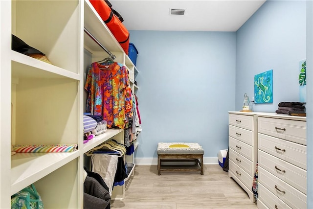 walk in closet with light wood-type flooring