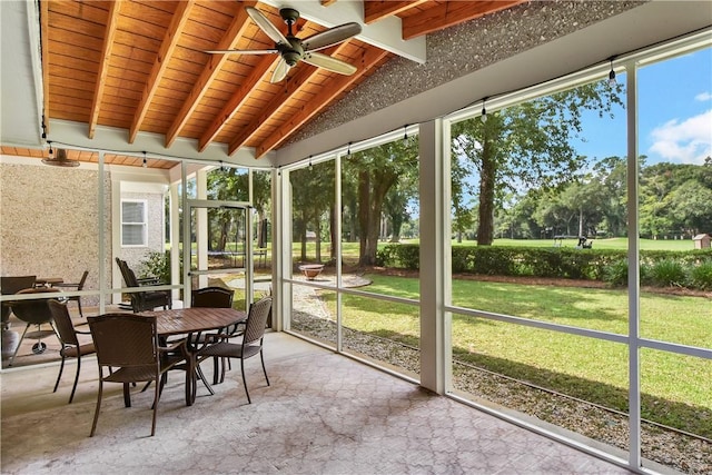 sunroom / solarium featuring lofted ceiling with beams and ceiling fan