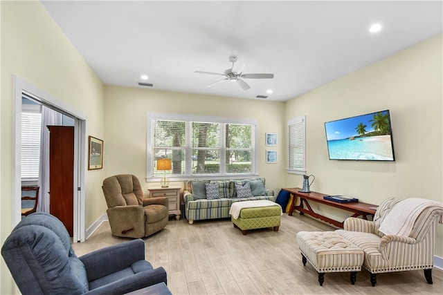 living room featuring ceiling fan and light wood-type flooring