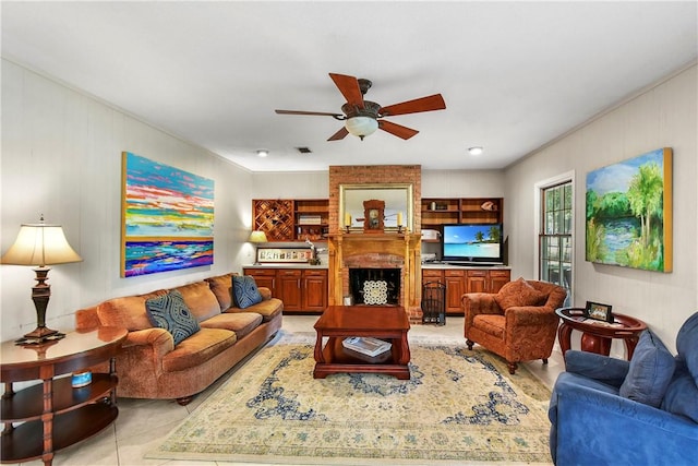 living room featuring ceiling fan, a fireplace, and light tile patterned flooring