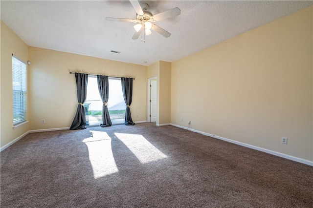 carpeted empty room with a textured ceiling and ceiling fan