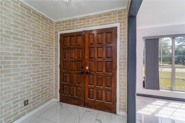1501 Charles St, Waycross, GA 31501 - entrance foyer with ornamental molding, brick wall, and marble look tiles