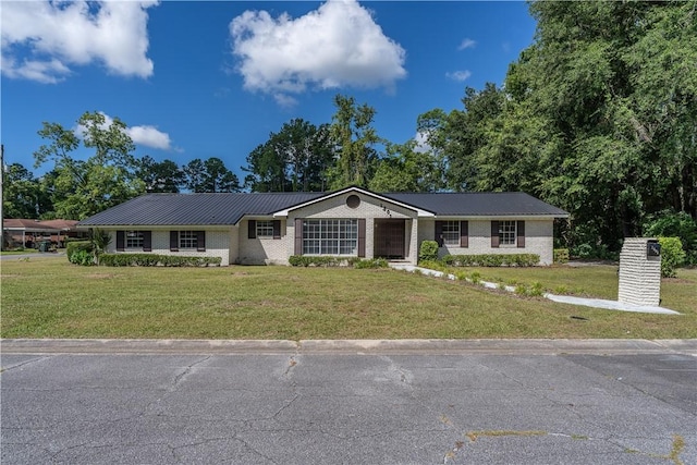 1501 Charles St, Waycross, GA 31501 - ranch-style house with a front lawn, a metal roof, and brick siding