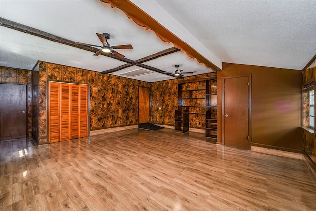 1501 Charles St, Waycross, GA 31501 - unfurnished living room with ceiling fan, wood finished floors, a textured ceiling, beamed ceiling, and wooden walls
