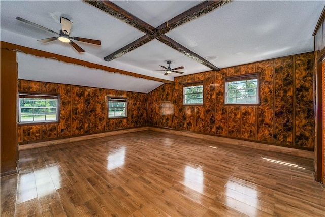 1501 Charles St, Waycross, GA 31501 - unfurnished room with wood finished floors, plenty of natural light, a ceiling fan, beam ceiling, and wooden walls