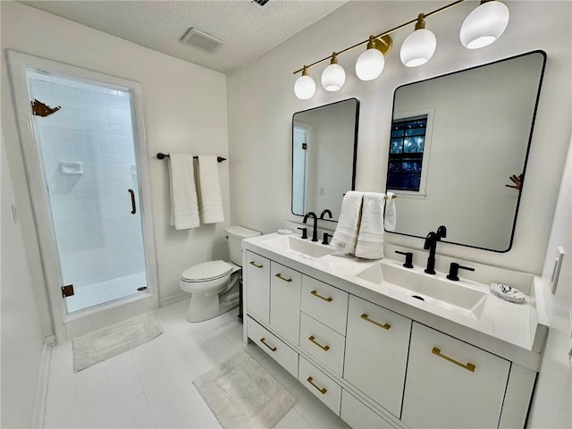 bathroom featuring a textured ceiling, visible vents, toilet, and a sink