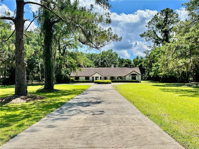 ranch-style home with a front yard and driveway