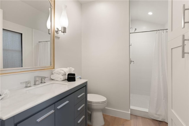 full bathroom featuring toilet, a shower with curtain, wood finished floors, and vanity