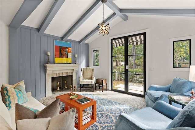 living room featuring a fireplace with flush hearth, vaulted ceiling with beams, carpet, french doors, and a chandelier