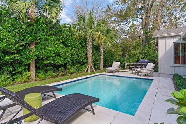 pool featuring a patio area and grilling area