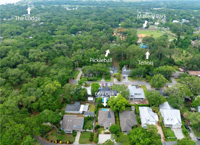 aerial view featuring a wooded view and a residential view