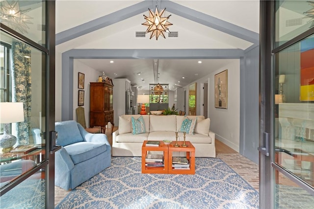 living room featuring baseboards, recessed lighting, and an inviting chandelier