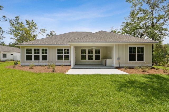 180 Ossabaw Way, Waverly, GA 31565 - back of property featuring roof with shingles, a yard, a patio area, and board and batten siding