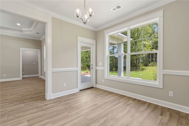 180 Ossabaw Way, Waverly, GA 31565 - unfurnished room featuring a chandelier, healthy amount of natural light, light wood-style flooring, and crown molding