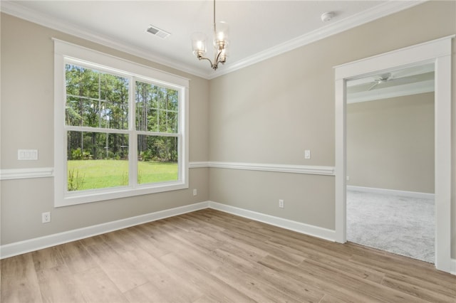 180 Ossabaw Way, Waverly, GA 31565 - empty room featuring ornamental molding, a chandelier, light wood finished floors, and a smoke detector