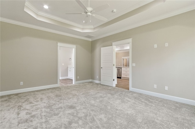 180 Ossabaw Way, Waverly, GA 31565 - unfurnished bedroom with a tray ceiling, connected bathroom, light colored carpet, ornamental molding, and recessed lighting