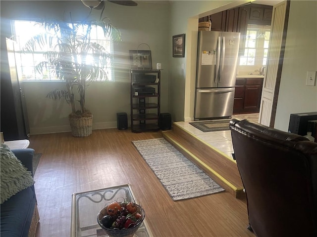 living room with sink, plenty of natural light, and light hardwood / wood-style floors