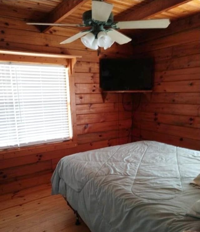 1518 To Jones Rd, Reidsville, GA 30453 - bedroom with wooden walls, hardwood / wood-style flooring, a wood ceiling with exposed beams, and a ceiling fan