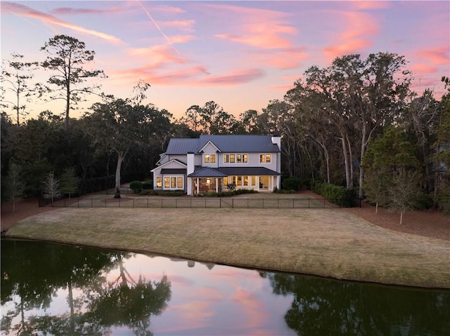 1241 Pikes Bluff Rd, Saint Simons Island, GA 31522 - back of property featuring dirt driveway, a water view, a metal roof, and a standing seam roof
