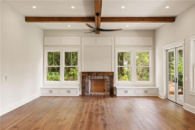 1241 Pikes Bluff Rd, Saint Simons Island, GA 31522 - unfurnished living room with a ceiling fan, wood finished floors, beam ceiling, a brick fireplace, and recessed lighting