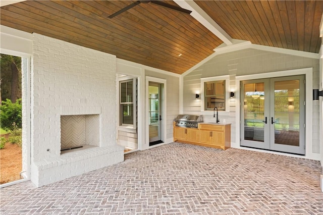1241 Pikes Bluff Rd, Saint Simons Island, GA 31522 - view of patio featuring french doors, an outdoor kitchen, an outdoor brick fireplace, and a ceiling fan