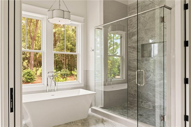 1241 Pikes Bluff Rd, Saint Simons Island, GA 31522 - full bath featuring a freestanding tub, marble finish flooring, and a shower stall