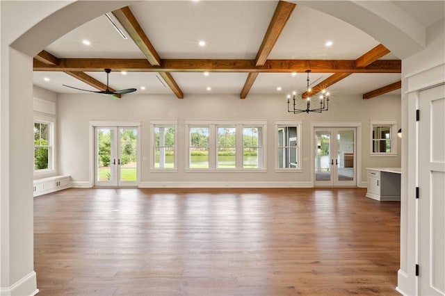 1241 Pikes Bluff Rd, Saint Simons Island, GA 31522 - unfurnished living room with french doors, beamed ceiling, a chandelier, arched walkways, and coffered ceiling