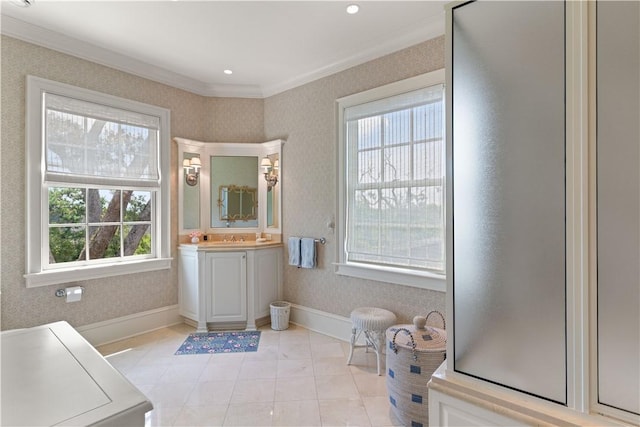 bathroom with tile patterned flooring, vanity, a wealth of natural light, and crown molding