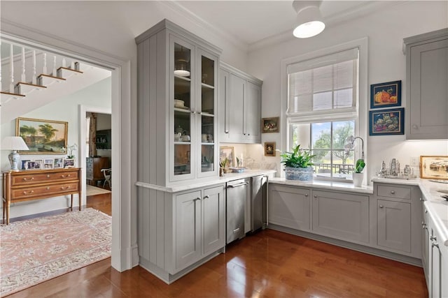 bar with gray cabinets, dark hardwood / wood-style flooring, and ornamental molding