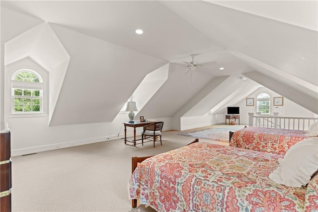 carpeted bedroom with ceiling fan and vaulted ceiling