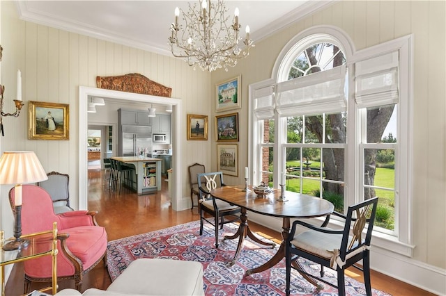 dining area featuring dark hardwood / wood-style flooring, wooden walls, crown molding, and a notable chandelier